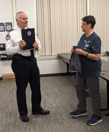 Vivian Wolpers, Program Officer, presents a plaque to Chief Manger